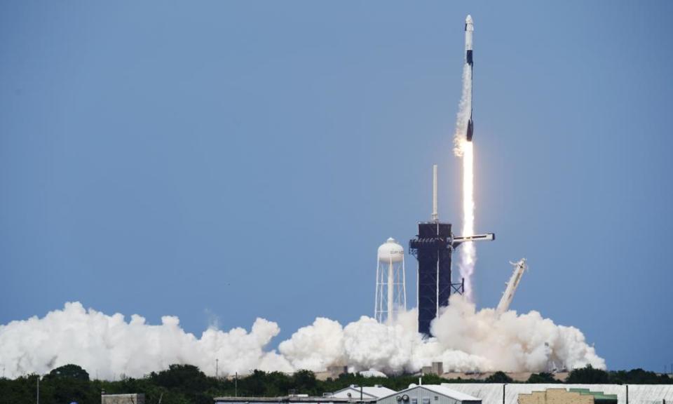 A SpaceX Falcon 9, with Nasa astronauts Doug Hurley and Bob Behnken in the Dragon crew capsule, lifts off from Cape Canaveral