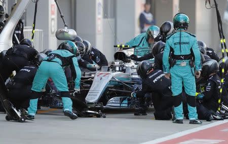 Formula One - F1 - Russian Grand Prix - Sochi, Russia - 30/04/17 - Pit crew and mechanics surround Mercedes Formula One driver Valtteri Bottas of Finland in the pit lane during the race. REUTERS/Valdrin Xhemaj/Pool