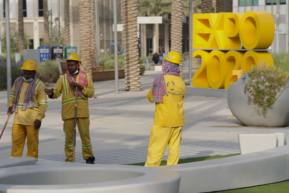 Workers clean an area at Expo 2020 in Dubai, United Arab Emirates, Sunday, Oct. 3, 2021. Dubai's Expo 2020 on Saturday, Oct. 2, 2021, offered conflicting figures for how many workers had been killed on site during construction of the massive world's fair, first saying five and then later three. In a later statement, Expo apologized and described the initial figure as a "mistake." (AP Photo/Jon Gambrell)