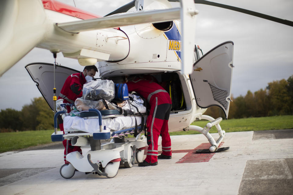 Medical personnel begin to load a coronavirus patient into a helicopter as they prepare to transfer the patient from the COVID-19 intensive care unit of the CHU Liege hospital to another hospital in Germany, in Liege, Belgium, Tuesday, Nov. 3 , 2020. (AP Photo/Francisco Seco)