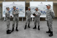 Russian officers talk to each other at a central atrium called the "Arctic Trefoil" on the Alexandra Land island near Nagurskoye, Russia, Monday, May 17, 2021. Once a desolate home mostly to polar bears, Russia's northernmost military outpost is bristling with missiles and radar and its extended runway can handle all types of aircraft, including nuclear-capable strategic bombers, projecting Moscow's power and influence across the Arctic amid intensifying international competition for the region's vast resources. (AP Photo/Alexander Zemlianichenko)