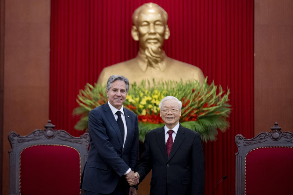 U.S. Secretary of State Antony Blinken, left, meets with Vietnam's Communist Party General Secretary Nguyen Phu Trong under a large statue of late Vietnamese revolutionary leader Ho Chi Minh at Communist Party of Vietnam Headquarters in Hanoi, Vietnam, Saturday, April 15, 2023. (AP Photo/Andrew Harnik, Pool)