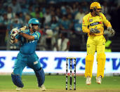 Chennai Super King captain Mahendra Singh Dhoni (R) reacts as his counterpart Pune Warriors India captain Sourav Ganguly looks on playing a shot during the IPL Twenty20 cricket match between Pune Warriors India and Chennai Super Kings at The Subrata Roy Sahara Stadium in Pune on April 14, 2012. AFP PHOTO/Indranil MUKHERJEE RESTRICTED TO EDITORIAL USE. MOBILE USE WITHIN NEWS PACKAGE (Photo credit should read INDRANIL MUKHERJEE/AFP/Getty Images)