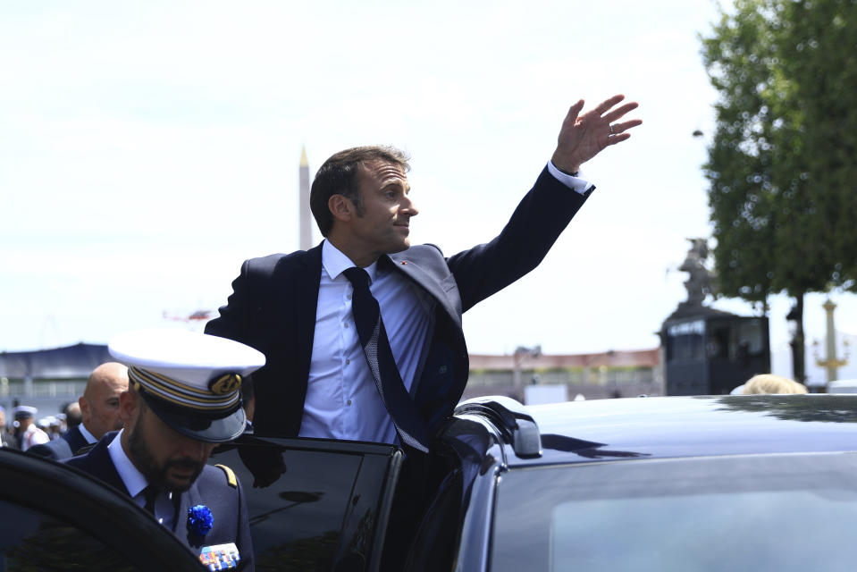 CORRECTS BYLINE - France's President Emmanuel Macron waves as he leaves the annual Bastille Day military parade in Paris, Friday, July 14, 2023. India is the guest of honor at this year's Bastille Day parade, with Prime Minister Narendra Modi in the presidential tribune alongside French President Emmanuel Macron. (AP Photo/Aurelien Morissard)