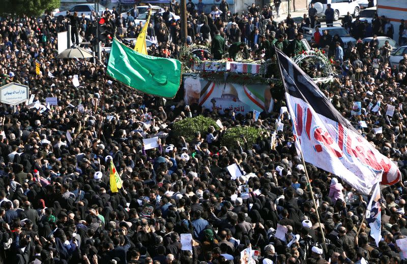 People attend a funeral procession for Soleimani and al-Muhandis, in Ahvaz