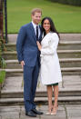 <p>Für die offizielle Bekanntgabe ihrer Verlobung wählte Meghan einen weißen Wickelmantel mit Gürtel des kanadischen Labels Line sowie ein schwarzes Kleid und nudefarbene Wildlederschuhe mit Absatz.<br><em>[Bild: Getty]</em> </p>