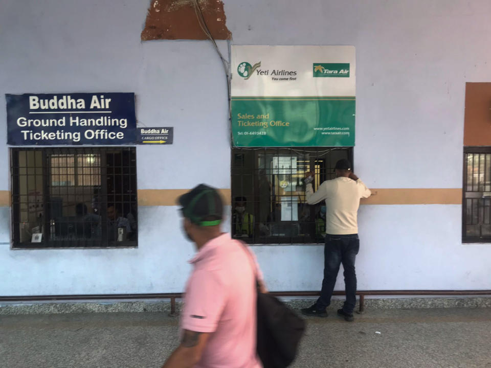 A man makes an enquiry outside a sales and ticketing office of Tara Airlines at the Tribhuvan International Airport in Kathmandu, Nepal, Sunday, May 29, 2022. A small airplane with 22 people on board flying on a popular tourist route was missing in Nepal’s mountains on Sunday, an official said. The Tara Airlines plane, which was on a 15-minute scheduled flight to the mountain town of Jomsom, took off from the resort town of Pokhara, 200 kilometers (125 miles) east of Kathmandu. It lost contact with the airport tower shortly after takeoff. (AP Photo/Niranjan Shreshta)