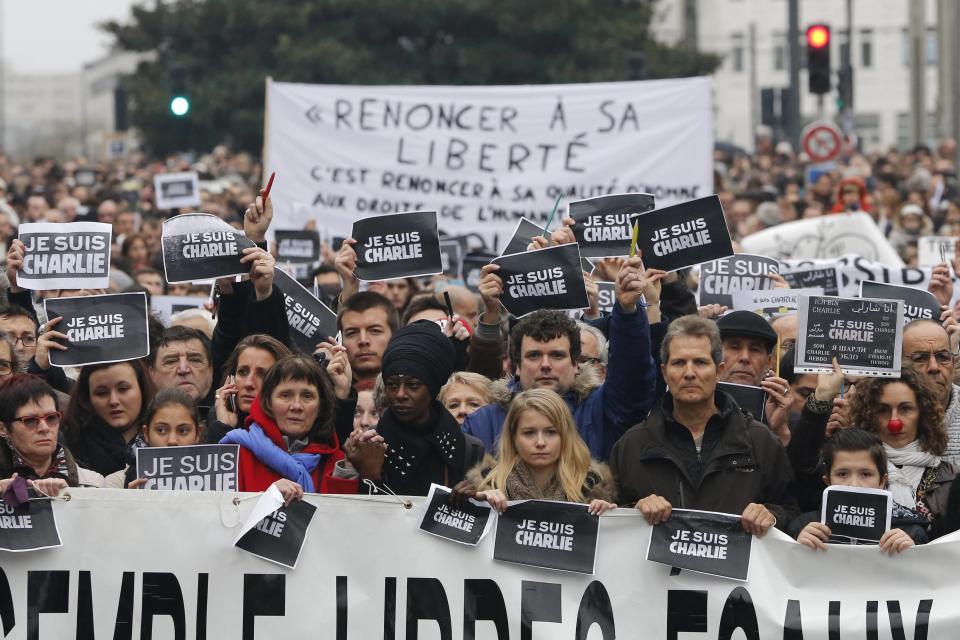 Several thousand people walk behind a banner as they march to pay tribute to the victims following a shooting Wednesday by gunmen at the office of the offices of the satirical weekly newspaper Charlie Hebdo during a demonstration in Nantes January 10, 2015. French police searched for a female accomplice to militant Islamists behind deadly attacks on the satirical Charlie Hebdo weekly newspaper and a kosher supermarket and maintained a top-level anti-terrorist alert ahead of a Paris gathering with European leaders and demonstration set for Sunday. In the worst assault on France's homeland security for decades, 17 victims lost their lives in three days of violence that began with an attack on the Charlie Hebdo weekly on Wednesday and ended with Friday's dual hostage-taking at a print works outside Paris and kosher supermarket in the city. The banner reads : live together, free, equal with solidarity. REUTERS/Stephane Mahe (FRANCE - Tags: CRIME LAW POLITICS SOCIETY CIVIL UNREST)