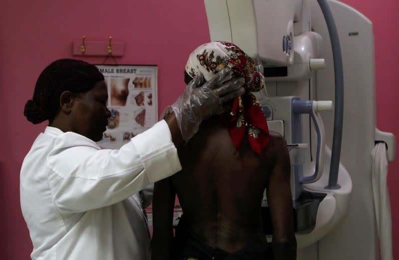 A patient prepares to undergo a mammogram X-ray picture of the breast to look for early signs of breast cancer in the radiology unit at the Kenyatta National Hospital in Nairobi