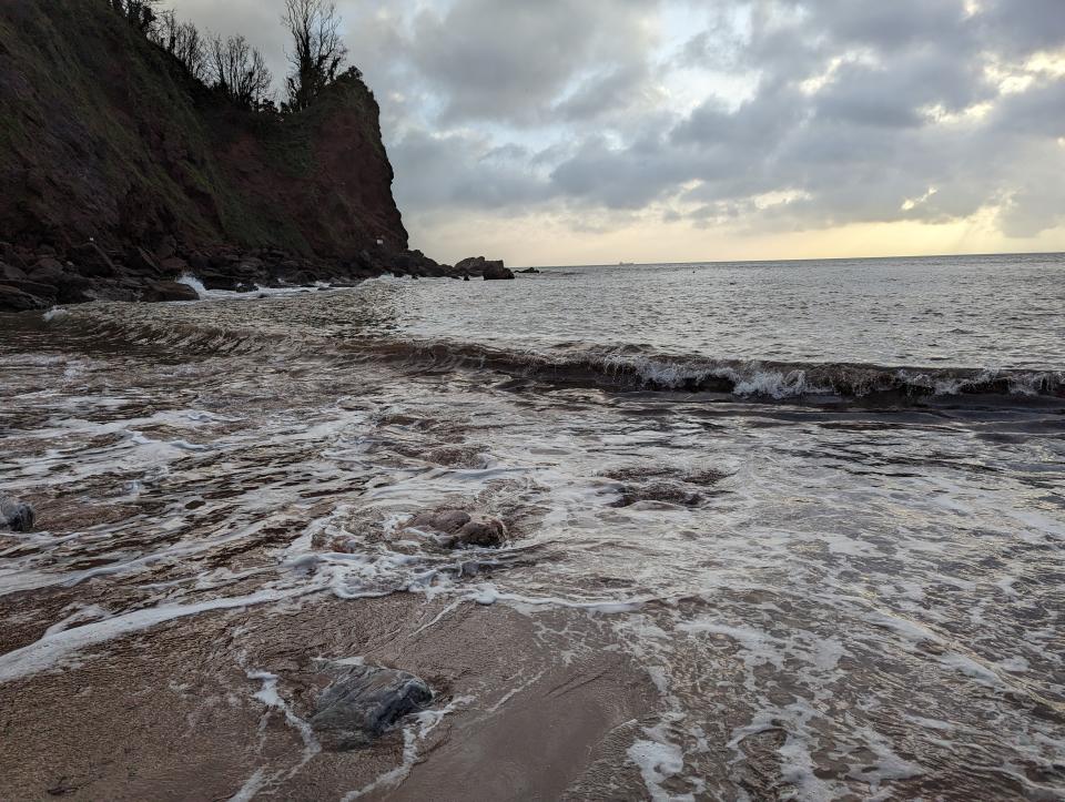 Sunrise beach with long exposure effect blurring the ocean water movement