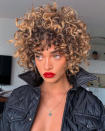 <p>This will be the coolest caramel-blonde curly cut in the room, every time. Plus, this haircut will do a great job at accentuating those cheekbones.</p>