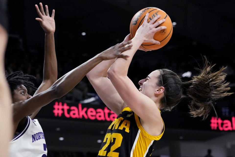 Iowa guard Caitlin Clark, right, shoots against Northwestern guard Melannie Daley during the first half of an NCAA college basketball game in Evanston, Ill., Wednesday, Jan. 31, 2024. (AP Photo/Nam Y. Huh)