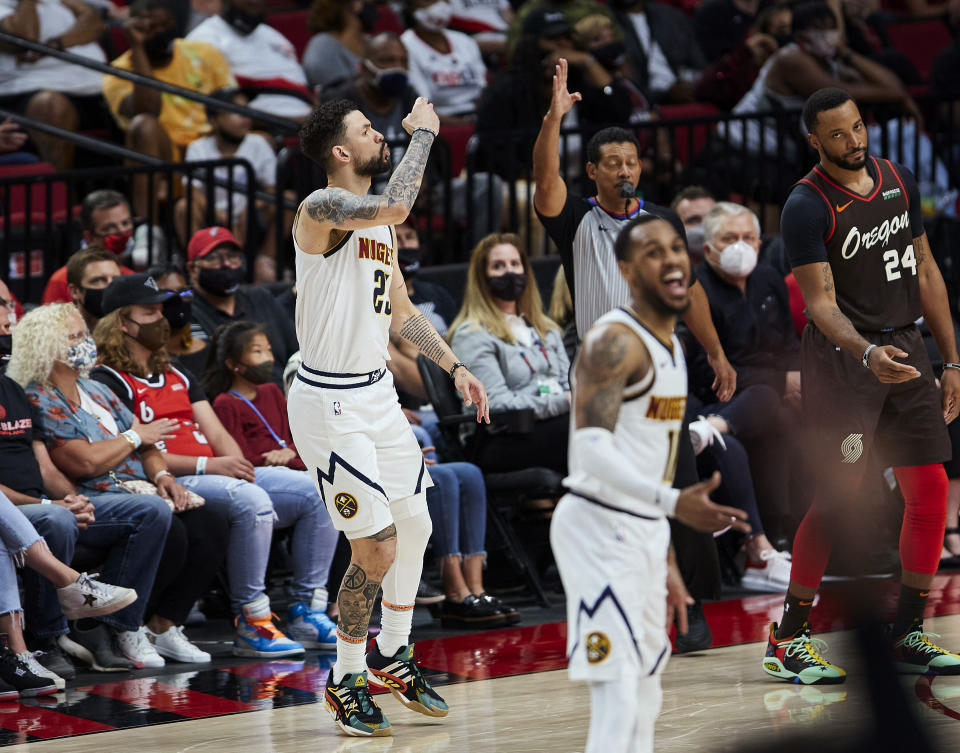 Denver Nuggets guard Austin Rivers, left, reacts after making a 3-point basket against the Portland Trail Blazers during the second half of Game 6 of an NBA basketball first-round playoff series Thursday, June 3, 2021, in Portland, Ore. (AP Photo/Craig Mitchelldyer)