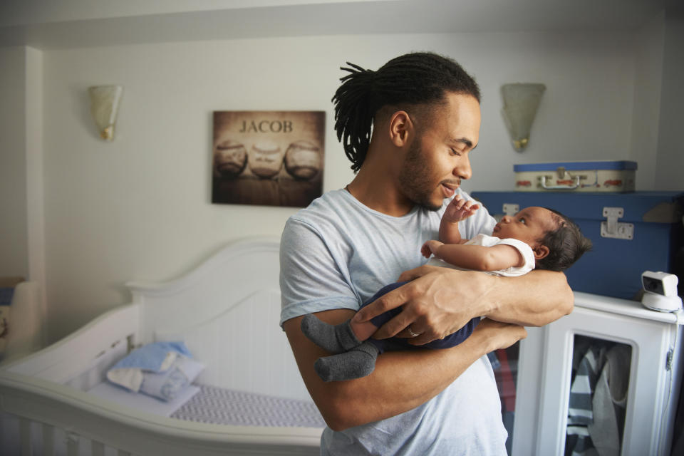 A young dad holding his baby