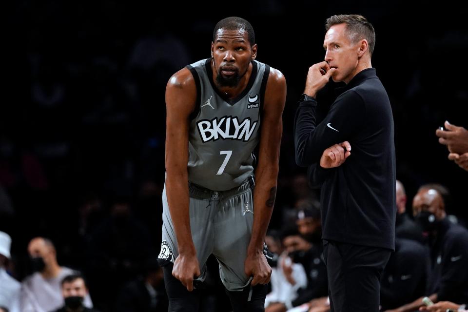 Brooklyn Nets forward Kevin Durant (7) talks to coach Steve Nash during the first half of the team's NBA basketball game against the Indiana Pacers, Friday, Oct. 29, 2021, in New York. (AP Photo/Mary Altaffer)