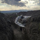 In this image released by World Press Photo, Thursday April 15, 2021, by Vaghinak Ghazaryan, tittle Resting Soldier, which won the third prize in the Contemporary Issues Singles category shows a soldier who lies in a trench, resting on a plastic cover, in the northeastern part of Syunik, Nerkin Khndzoresk, Armenia, on 31 October 2020. (Vaghinak Ghazaryan, World Press Photo via AP)