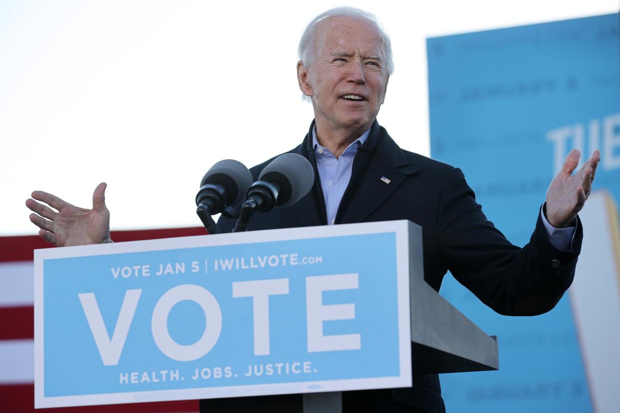 President-elect Joe Biden addresses a campaign rally with Democratic candidates for the U.S. Senate Jon Ossoff and Rev. Raphael Warnock the day before their runoff election in the parking lot of Center Parc Stadium January 04, 2021 in Atlanta, Georgia. Biden's trip comes a day after the release of a recording of an hourlong call where President Donald Trump seems to pressure Georgia Secretary of State Brad Raffensperger to “find” the votes he would need to reverse the presidential election outcome in the state.