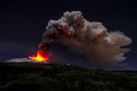 Lava and smoke provide a violent contrast to the serenity of the night sky. (Rex)