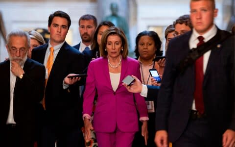 US speaker of the House, Nancy Pelosi (C) walks with reporters, before the Democrat controlled House of Representatives passed a resolution condemning US President Donald Trump for his "racist comments"  - Credit: AFP