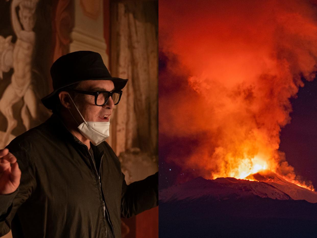 left; director joe wright on the set on cyrano, standing wearing a mask around his chin and brimmed hat on his head; right: the december 2020 eruption of mount etna showing the volcano spewing lava and ash into the air