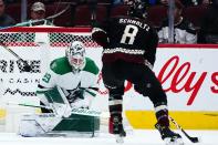 Arizona Coyotes center Nick Schmaltz (8) scores a goal against Dallas Stars goaltender Jake Oettinger (29) during the second period of an NHL hockey game Sunday, Feb. 20, 2022, in Glendale, Ariz. (AP Photo/Ross D. Franklin)