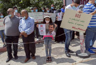 Palestinians carry posters showing Mahmoud Nawajaa, a leading coordinator of the Palestinian-led boycott movement against Israel, BDS, during a protest calling for the EU to press for his release, in front of the German Representative Office, in the West Bank city of Ramallah, Tuesday, Aug. 11, 2020. The activist was arrested on July 30, remains in Israeli custody and has not been charged. Israel says the arrest is not connected to his boycott activities, and that he is is suspected of unspecified “security offenses," but boycott activists accuse Israel of fabricating the case in order to justify the arrest. (AP Photo/Nasser Nasser)