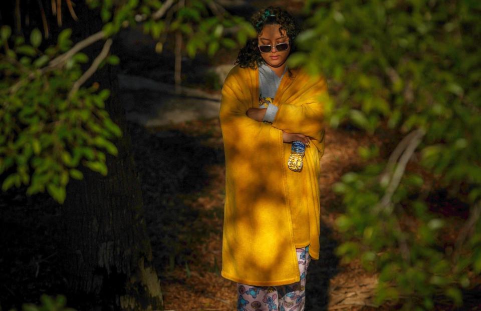 Stefanny Maldonado, West Palm Beach, starts her day with prayers at Dreher Park in West Palm Beach, Fla., on Monday, January 23, 2022. Overnight lows dipped into the mid 40s and the forecast is for for daytime highs in the mid 70s through midweek. Maldonado had an unexpected morning off from work and took the time to herself at the park, she said.