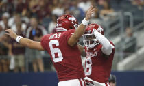 Arkansas quarterback Ben Hicks (6) and wide receiver Mike Woods (8) celebrate a touchdown pass against Texas A&M during the first half of an NCAA college football game Saturday, Sept. 28, 2019, in Arlington, Texas. (AP Photo/Ron Jenkins)