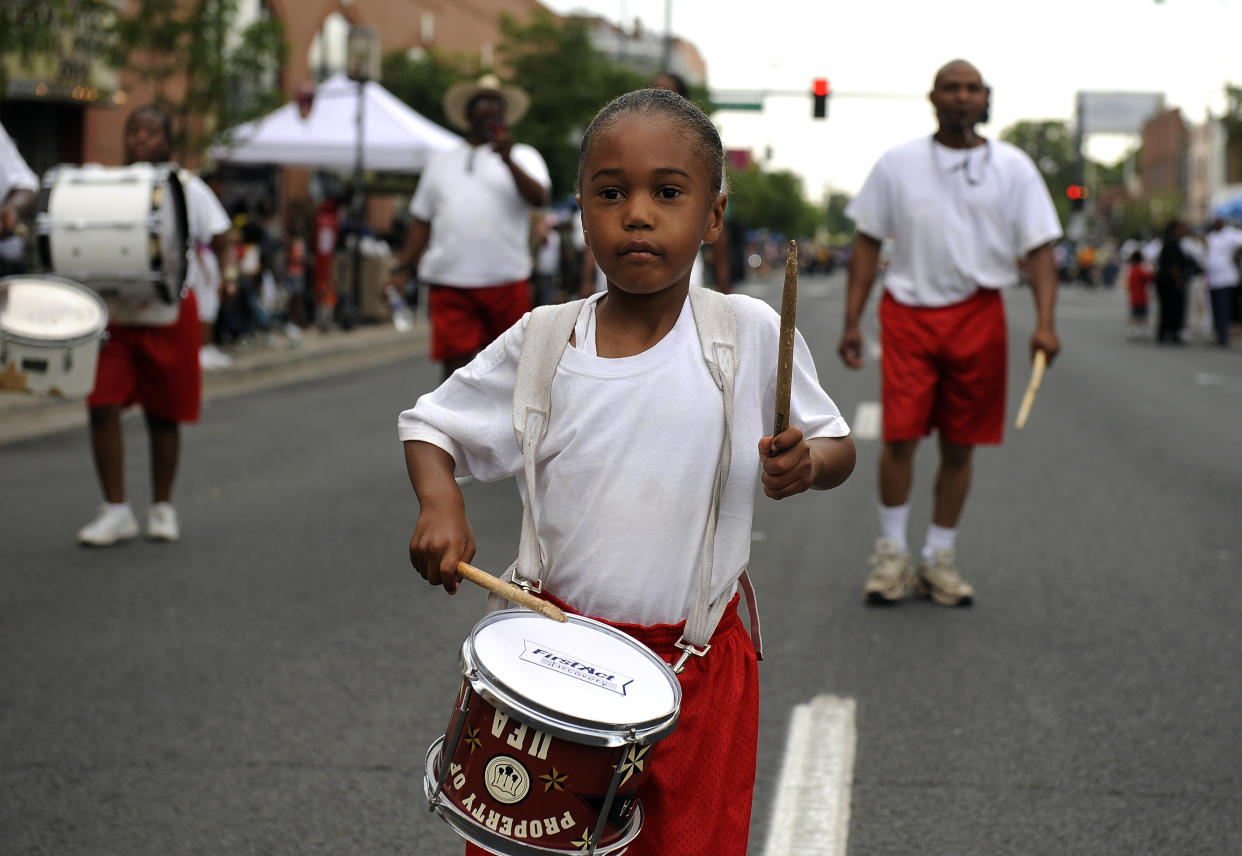 Gabriel Buckmon, 5, plays with the Syrian Temple 49 Youth Drum & Flag Corps during the Juneteenth Parade, in the historic Five Points neighborhood, in Denver, CO. (Craig F. Walker / The Denver Post via Getty Images)