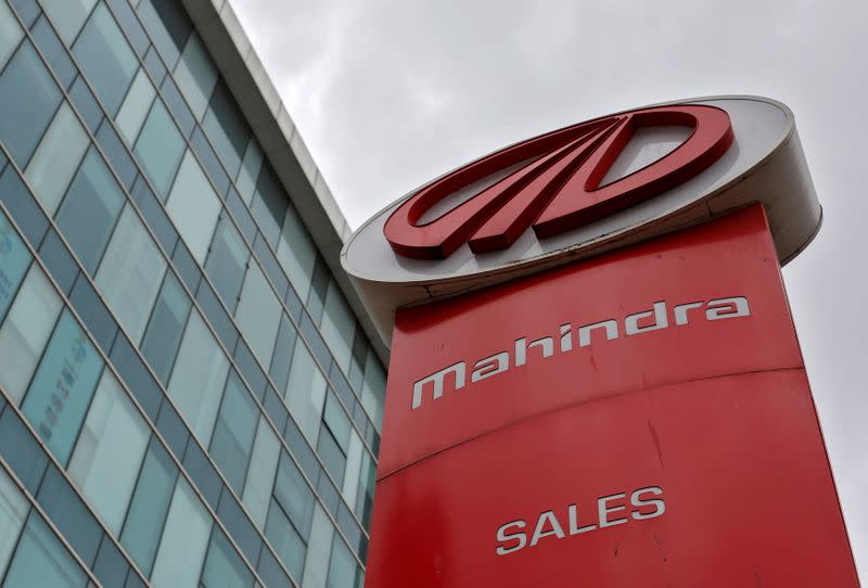 FILE PHOTO: FILE PHOTO: A Mahindra and Mahindra sign at one of the carmaker's showrooms in Mumbai