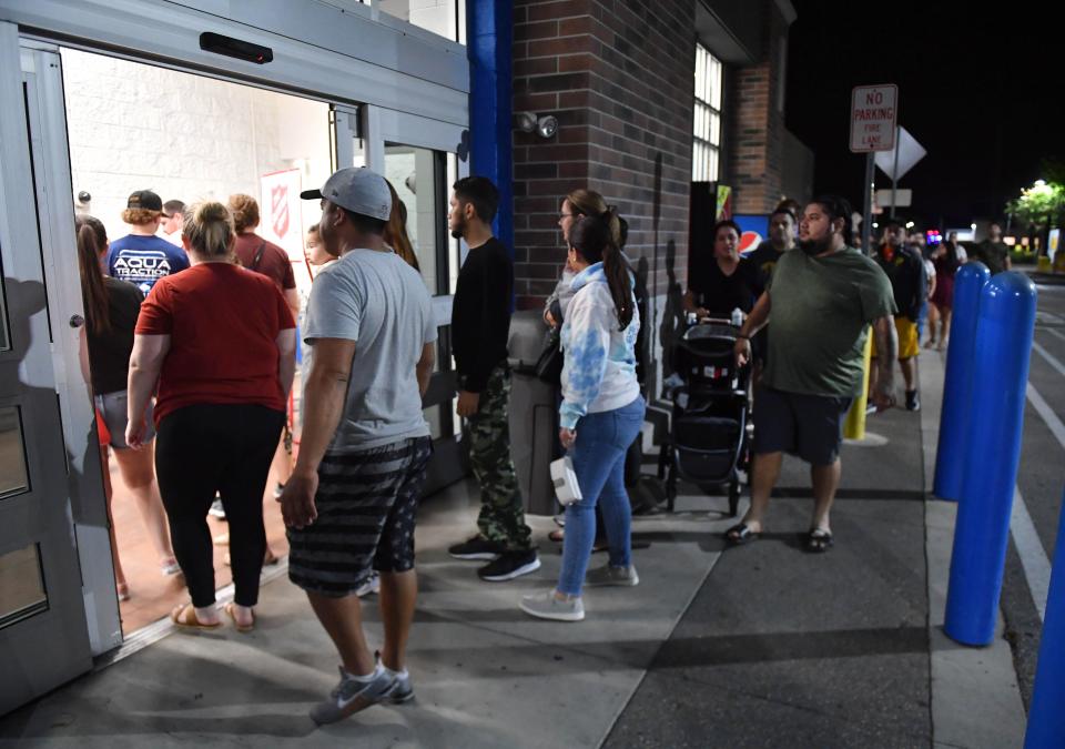 Black Friday shoppers enter the Walmart store at North Lockwood Ridge Road and University Parkway as the doors opened at 6 a.m. on Friday, Nov. 25, 2022 in Sarasota.