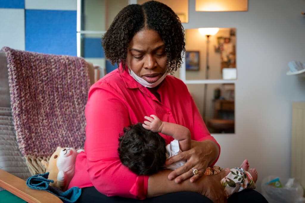 Capri Isidoro, of Ellicott City, Md., looks at her one-month-old baby Charlotte, Monday, May 23, 2022, in Columbia, Md., during a lactation consultation. Charlotte was delivered via emergency C-section and given formula by hospital staff. Isidoro has been having trouble with breastfeeding and has been searching for a formula that her daughter can tolerate well. (AP Photo/Jacquelyn Martin)