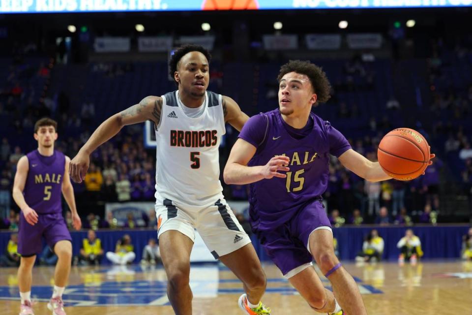 Max Gainey of Male drives past Tylon Webb of Frederick Douglass during Friday night’s quarterfinal matchup in Rupp Arena.