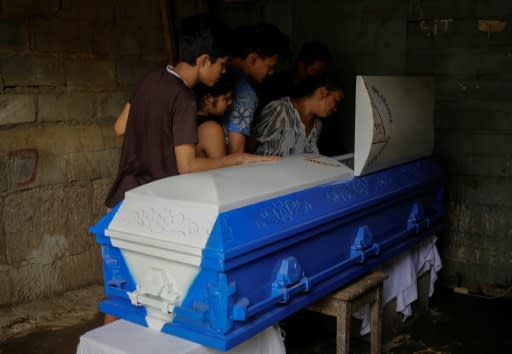 Friends and relatives look at the body of one of those killed during violent clashes amid a nationwide strike against Nicaragua's President Daniel Ortega