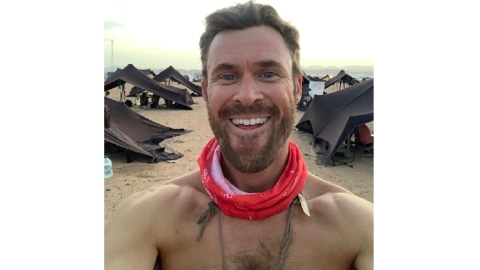 Ultrarunner Maj. Chas Kabanuck takes a selfie with the Bedouin tents provided to participants in the Marathon des Sables in Morocco in April 2023. (Courtesy of Chas Kabanuck)