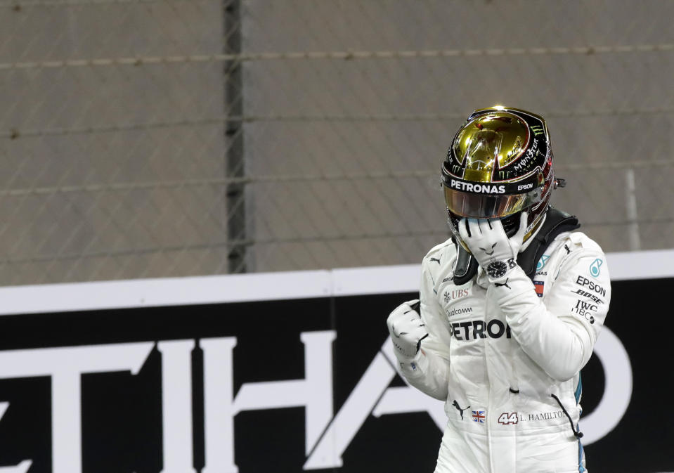 Mercedes driver Lewis Hamilton of Britain celebrates after getting the pole position in the qualifying session for the Emirates Formula One Grand Prix at the Yas Marina racetrack in Abu Dhabi, United Arab Emirates, Saturday, Nov. 24, 2018. The Emirates Formula One Grand Prix will take place on Sunday. (AP Photo/Luca Bruno)