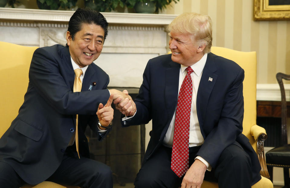 Japanese Prime Minister Shinzo Abe, left, shakes hands with Trump during their meeting in the Oval Office at the White House on Feb. 10, 2017.