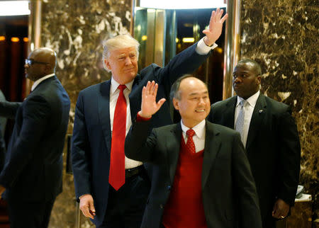 U.S. President-elect Donald Trump and Softbank CEO Masayoshi Son acknowledge guests after meeting at Trump Tower in Manhattan, New York City, U.S., December 6, 2016. REUTERS/Brendan McDermid