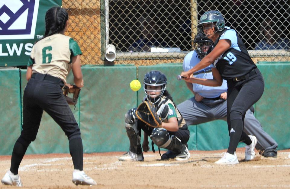 Delaware Division 3's Jaya Shaub drives the ball to the fence for a triple in game against Asia Pacific Thursday.  The team from Lower Sussex won the contest 3-0.