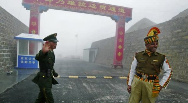 PICTURED: A Chinese and Indian soldier at the Nathu La border crossing between India and China in India's Sikkim state. Photo: AFP