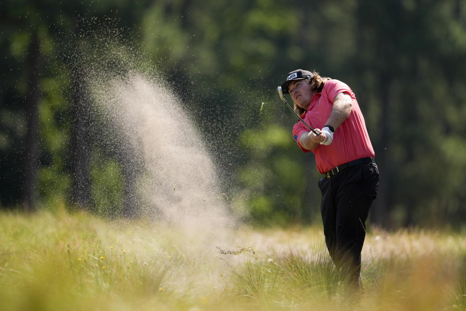 Neal Shipley hits from the native area on the fifth hole during the first round of the U.S. Open golf tournament Thursday, June 13, 2024, in Pinehurst, N.C. (AP Photo/George Walker IV)