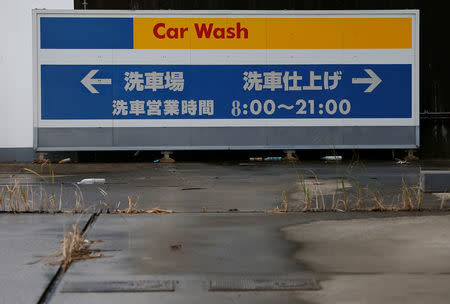 Weeds are seen at a temporarily closed gas station in Chiba, east of Tokyo, Japan June 28, 2017. REUTERS/Issei Kato