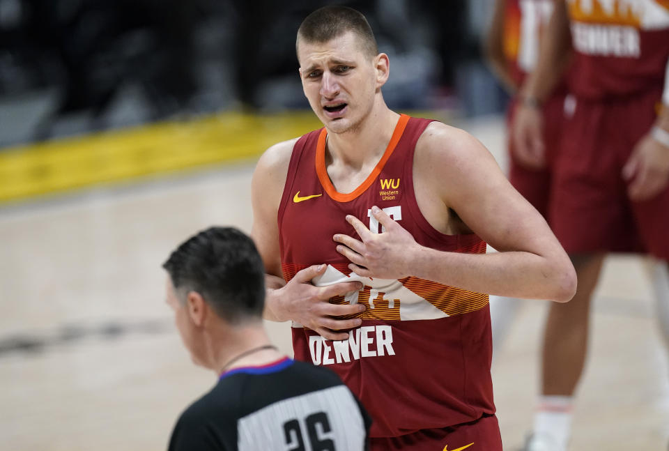 Denver Nuggets center Nikola Jokic argues with referee Pat Fraher for a call during the first half of the team's NBA basketball game against the Miami Heat on Wednesday, April 14, 2021, in Denver. (AP Photo/David Zalubowski)