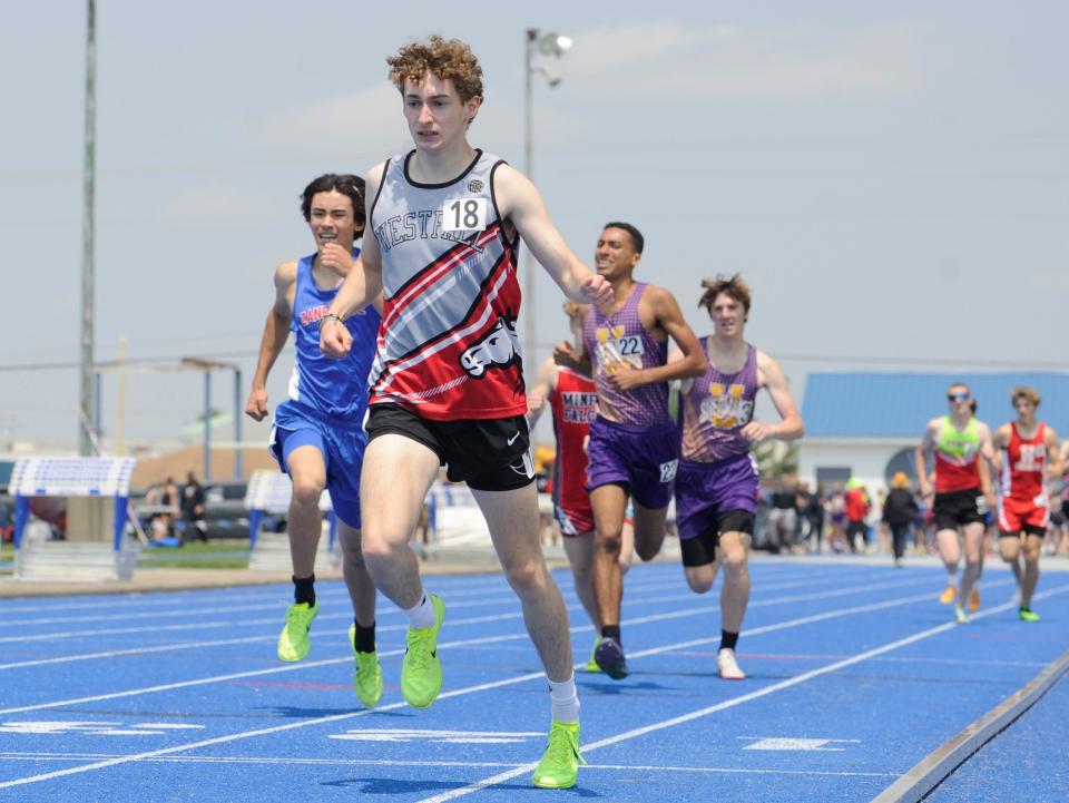 Westfall's Josh Trapp crosses the finish line during the boys 800-meter run in the Division II district track and field meet at Washington High School on May 20, 2023.