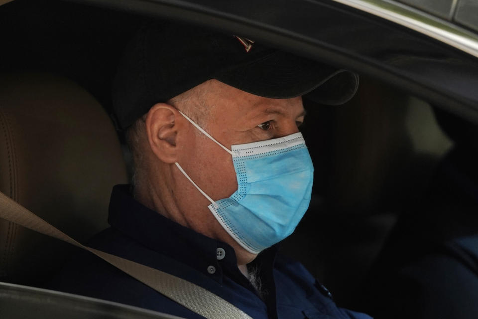Peter Daszak of the World Health Organization team sits in a car on his way to a field visit in Wuhan in central China's Hubei province on Friday, Jan. 29, 2021. Daszak, part of the team investigating the origins of the coronavirus in Wuhan, says the Chinese side granted full access to all sites and personnel they requested to visit and meet with. (AP Photo/Ng Han Guan)