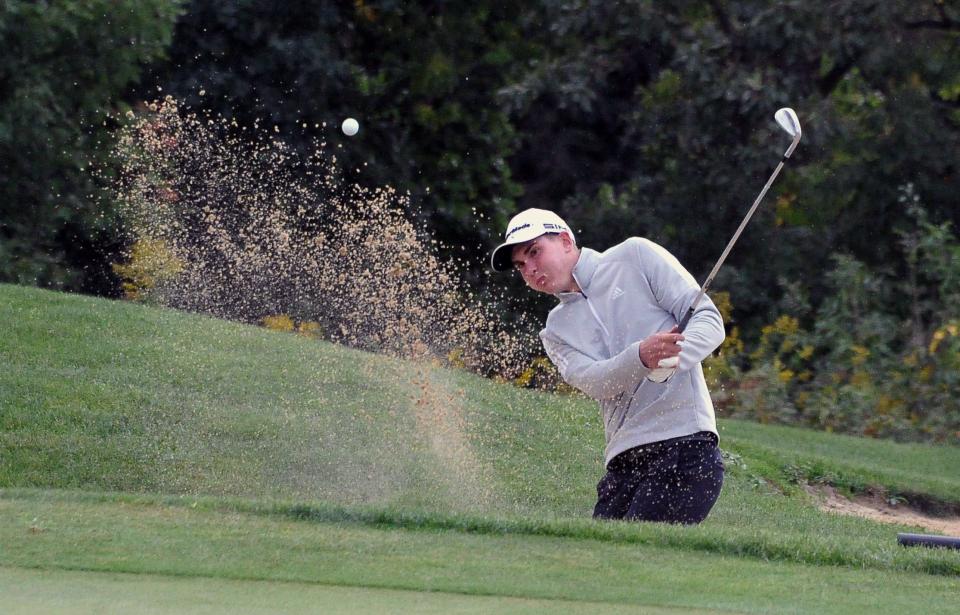 Dalton's Jaden Schlabach hits out of a sand trap onto the green.