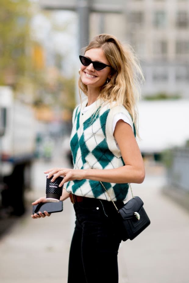 A showgoer wearing a preppy sweater during New York Fashion Week in September.