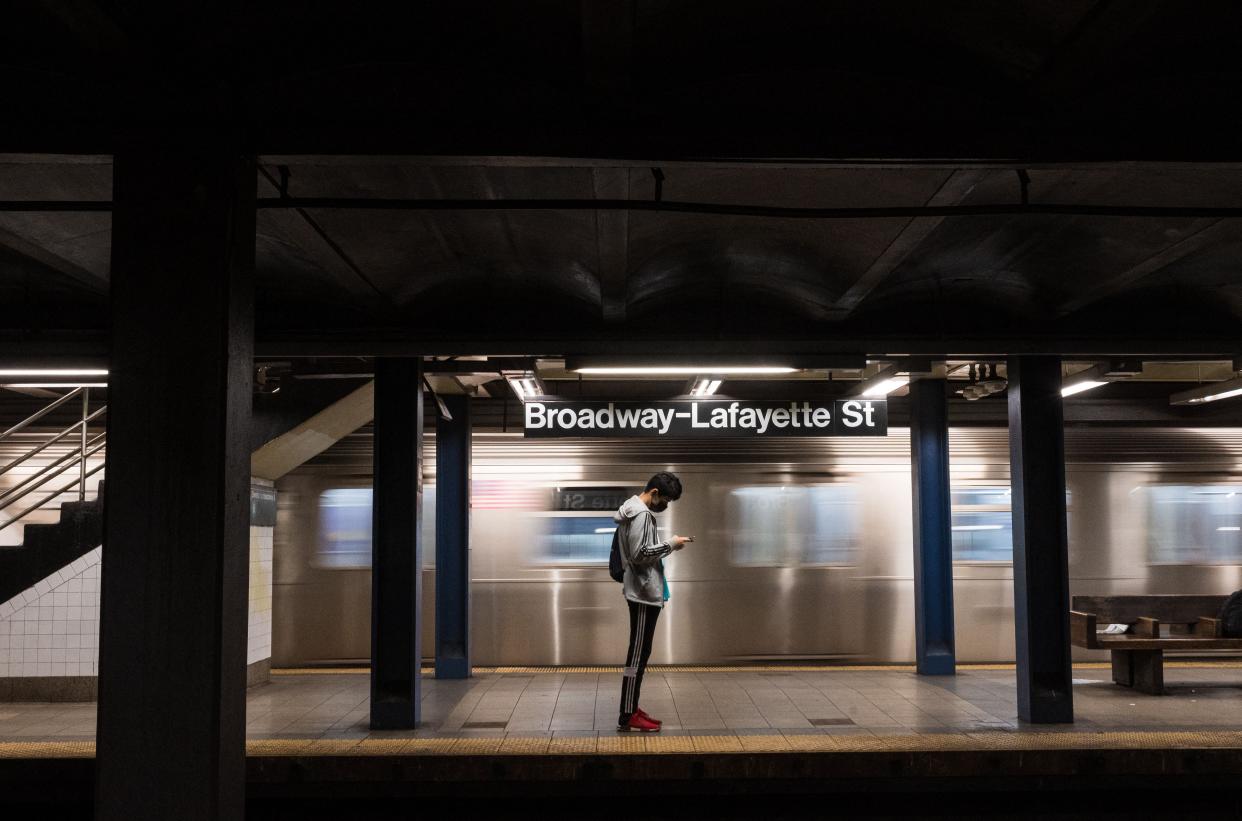 <p>A person checks their phone on a subway platform as the subway returns to twenty-four hour service on May 17, 2021 in New York City.  Ridership dropped by 90% during 2020.</p> (Getty)