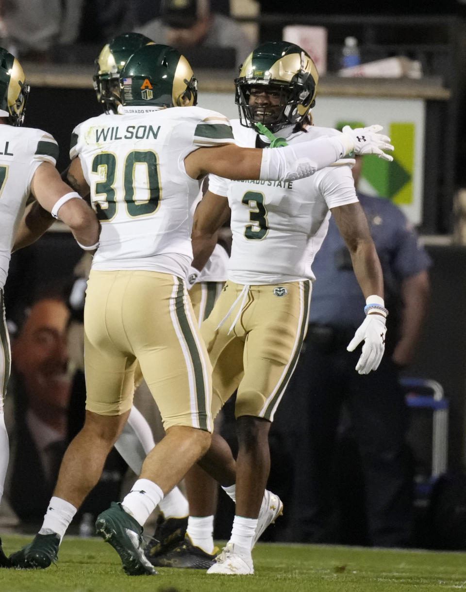 Colorado State linebacker Chase Wilson (30) congratulates defensive back Ron Hardge III (3) after Hardge returned a fumble for a touchdown in the first half of an NCAA college football game against Colorado, Saturday, Sept. 16, 2023, in Boulder, Colo. (AP Photo/David Zalubowski)