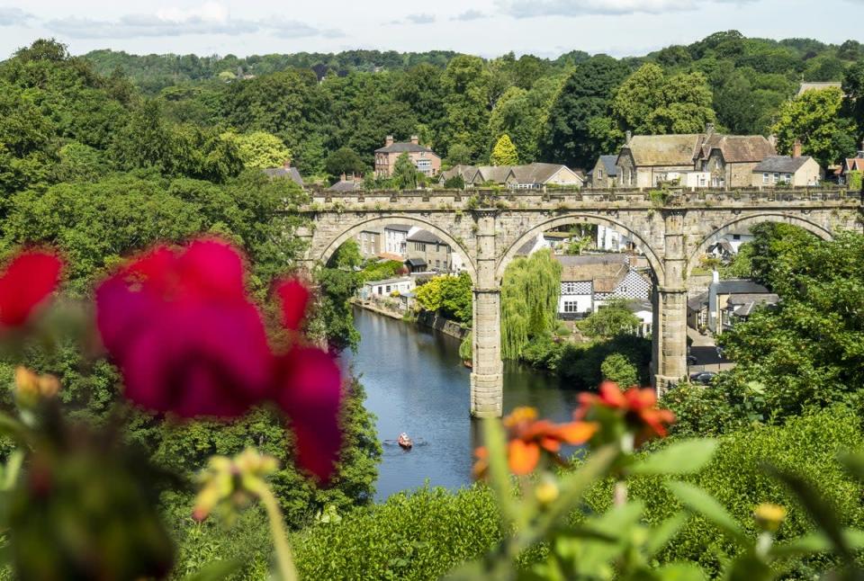 People enjoy the hot weather in a rowing boat underneath the Knaresborough Viaduct (Danny Lawson/PA) (PA Wire)